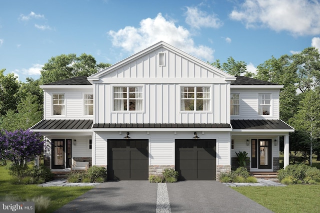 modern inspired farmhouse featuring a standing seam roof, asphalt driveway, board and batten siding, a garage, and covered porch