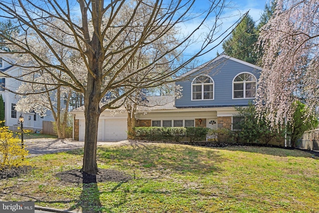 1220 Wendover Rd, Bryn Mawr, PA 19010 - traditional home featuring driveway, a front yard, fence, an attached garage, and stone siding
