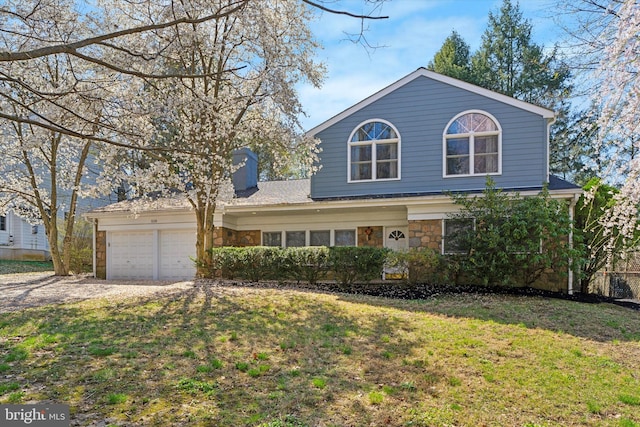 1220 Wendover Rd, Bryn Mawr, PA 19010 - traditional home with stone siding, a garage, a chimney, and a front lawn