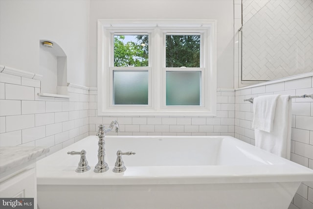 1220 Wendover Rd, Bryn Mawr, PA 19010 - bathroom with a wainscoted wall, tile walls, and a bath