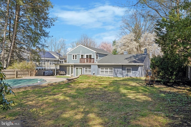 1220 Wendover Rd, Bryn Mawr, PA 19010 - back of house featuring a chimney, a fenced backyard, a balcony, a yard, and a fenced in pool