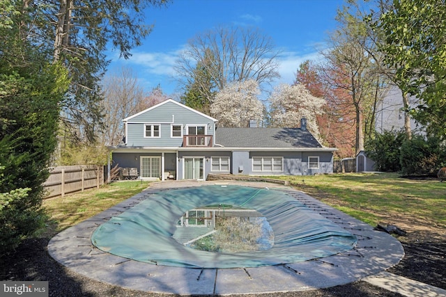 1220 Wendover Rd, Bryn Mawr, PA 19010 - rear view of property featuring a balcony, a fenced in pool, fence, an outdoor structure, and a shed
