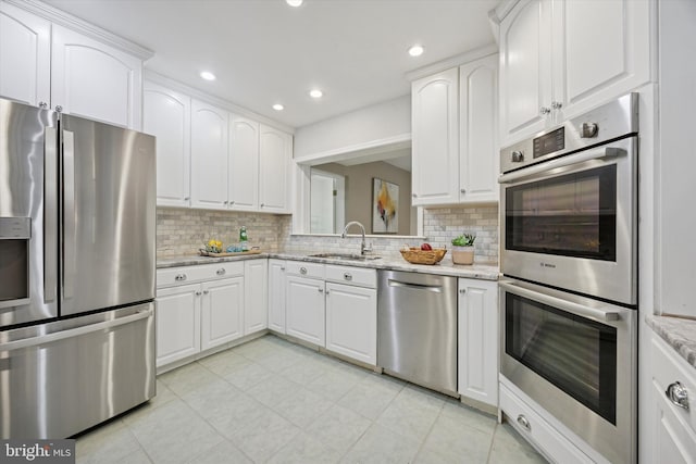 1220 Wendover Rd, Bryn Mawr, PA 19010 - kitchen featuring a sink, light stone countertops, decorative backsplash, and appliances with stainless steel finishes