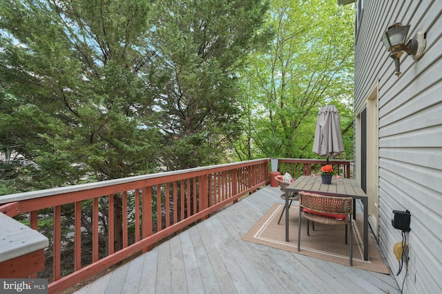 wooden terrace featuring outdoor dining space