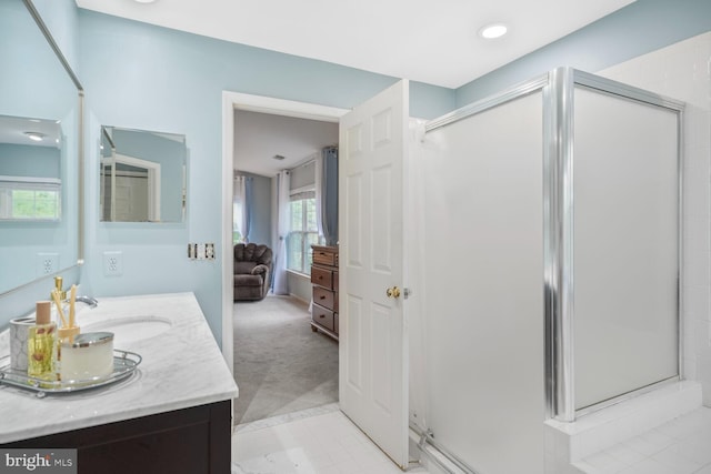 ensuite bathroom featuring vanity, ensuite bathroom, a stall shower, and tile patterned floors