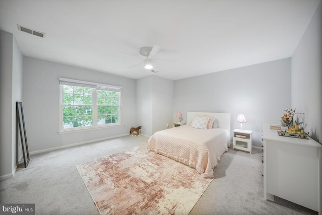 bedroom with visible vents, baseboards, ceiling fan, and light colored carpet