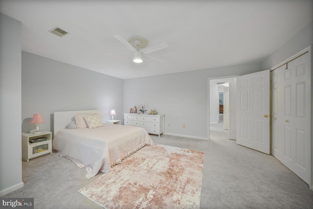 carpeted bedroom featuring a ceiling fan, baseboards, visible vents, and a closet