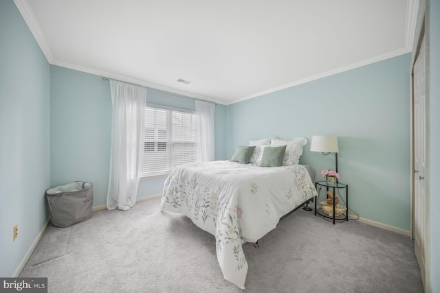 carpeted bedroom with baseboards, ornamental molding, and visible vents