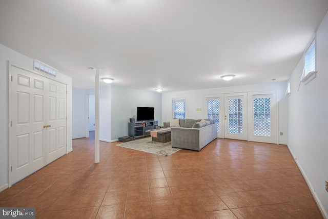 tiled living room featuring baseboards