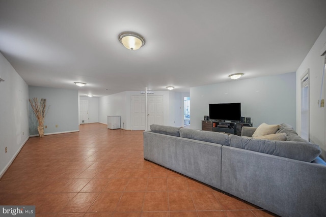 living area featuring baseboards and light tile patterned floors
