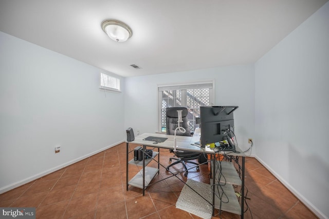 tiled office with baseboards and visible vents