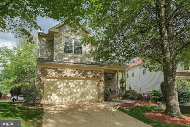 view of front of property with an attached garage, driveway, and brick siding
