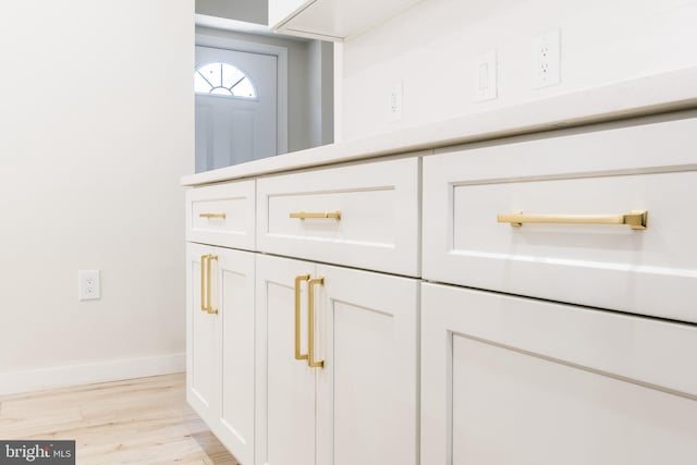 room details with baseboards and wood finished floors