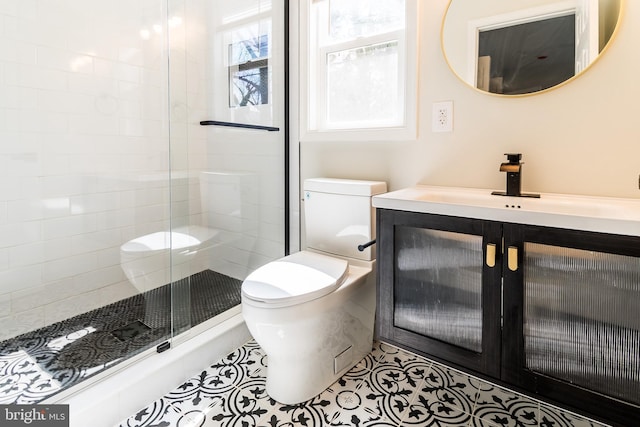 bathroom featuring vanity, tile patterned floors, a stall shower, and toilet