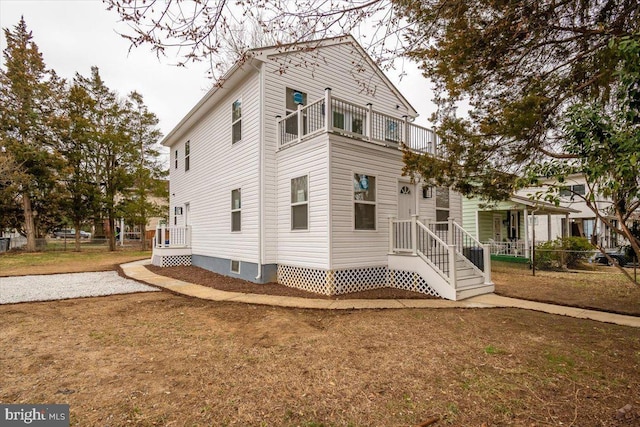 exterior space with fence and a balcony