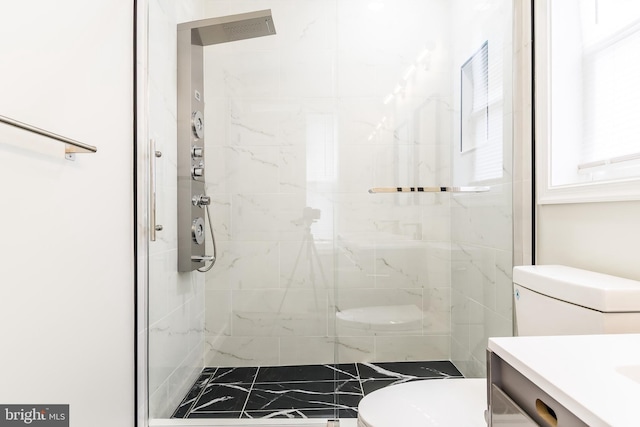 full bathroom with vanity, a shower stall, and toilet