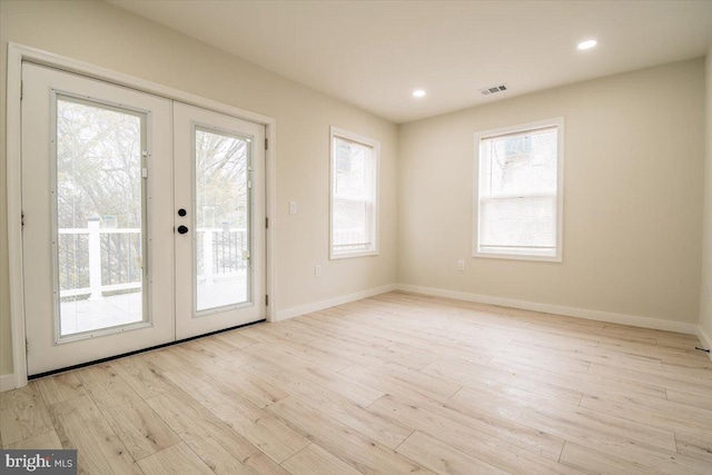 doorway with visible vents, wood finished floors, and french doors