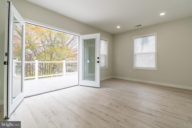 interior space featuring recessed lighting, baseboards, visible vents, and wood finished floors