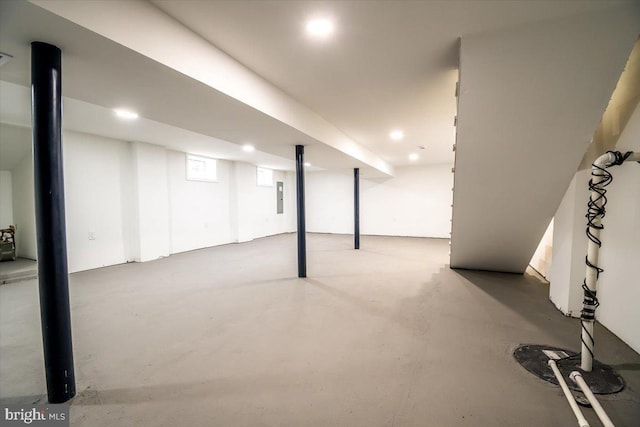 basement featuring electric panel and recessed lighting