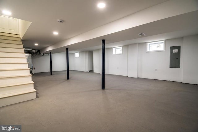 below grade area featuring recessed lighting, stairs, electric panel, and visible vents