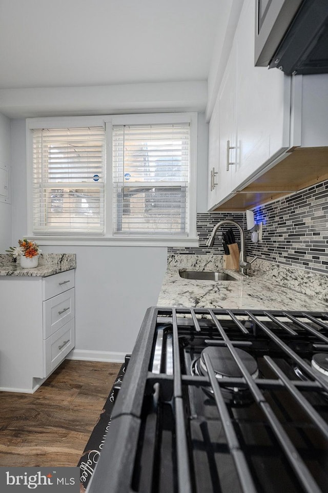 4003 25th Ave, Temple Hills, MD 20748 - kitchen with a sink, light stone countertops, dark wood-style flooring, and white cabinetry