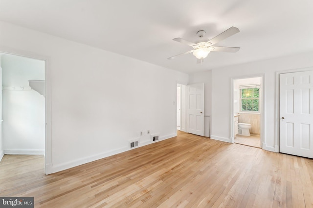 unfurnished bedroom with a closet, baseboards, visible vents, and light wood-style floors