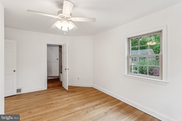 unfurnished bedroom featuring a ceiling fan, baseboards, visible vents, and light wood-style floors