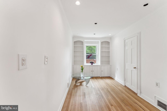 hall featuring visible vents, built in shelves, baseboards, light wood-style floors, and recessed lighting