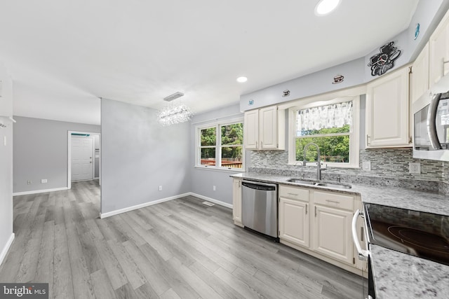 5983 Ridge Spring Cir, Salisbury, MD 21801 - kitchen featuring a sink, appliances with stainless steel finishes, tasteful backsplash, light wood-style floors, and recessed lighting