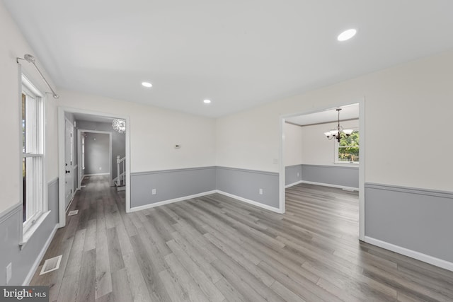 5983 Ridge Spring Cir, Salisbury, MD 21801 - empty room with a chandelier, wood finished floors, baseboards, and recessed lighting