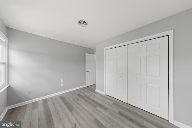 5983 Ridge Spring Cir, Salisbury, MD 21801 - unfurnished bedroom featuring wood finished floors, baseboards, and a closet