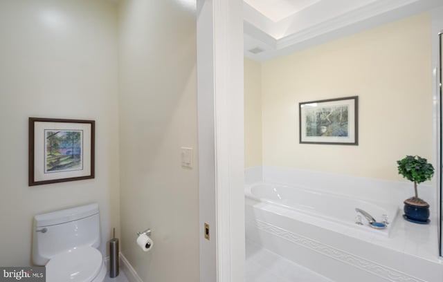 full bathroom featuring toilet and a garden tub