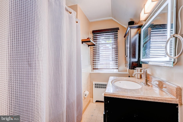 full bath featuring vanity, curtained shower, radiator heating unit, tile patterned floors, and vaulted ceiling