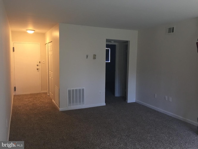 unfurnished room with visible vents, baseboards, and carpet
