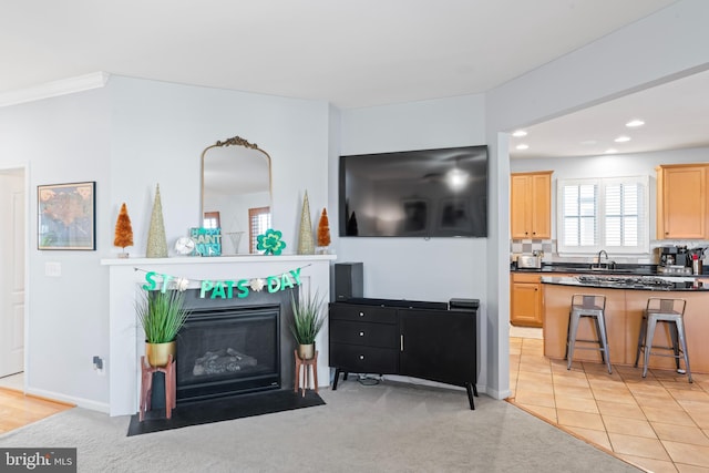 living room with baseboards, a fireplace with flush hearth, light colored carpet, recessed lighting, and light tile patterned flooring