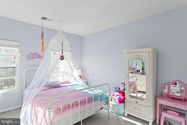 bedroom with visible vents and carpet flooring