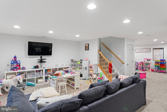 carpeted living area with stairway and recessed lighting