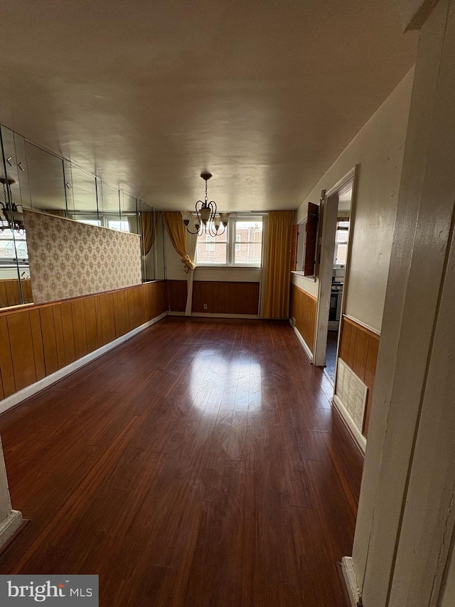 1536 E Pastorius St, Philadelphia, PA 19138 - spare room featuring dark wood-type flooring, a wainscoted wall, wooden walls, and a notable chandelier