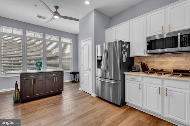 5613 Havenwood Ct, Upper Marlboro, MD 20772 - kitchen with decorative backsplash, light wood finished floors, visible vents, a ceiling fan, and appliances with stainless steel finishes
