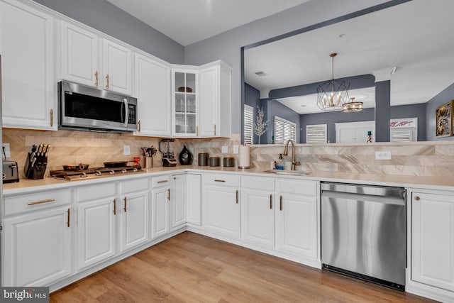 5613 Havenwood Ct, Upper Marlboro, MD 20772 - kitchen featuring a sink, tasteful backsplash, appliances with stainless steel finishes, and a chandelier