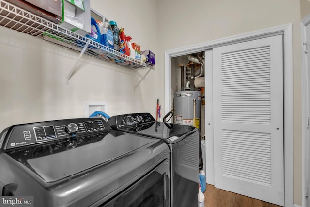 5613 Havenwood Ct, Upper Marlboro, MD 20772 - laundry area featuring washing machine and clothes dryer, wood finished floors, laundry area, and water heater