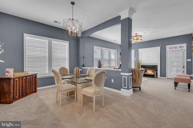 5613 Havenwood Ct, Upper Marlboro, MD 20772 - dining area with light colored carpet, an inviting chandelier, baseboards, visible vents, and a fireplace
