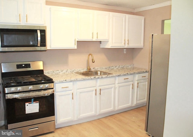 217 Kinsley Rd, Pemberton, NJ 08068 - kitchen with stainless steel appliances, a sink, ornamental molding, white cabinetry, and light wood-style floors