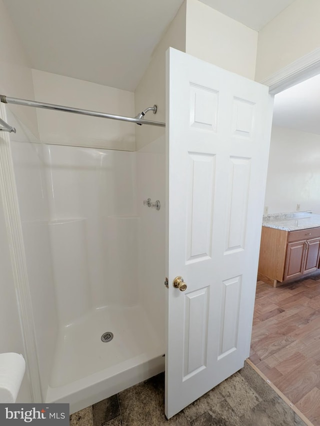 bathroom with a shower and vanity