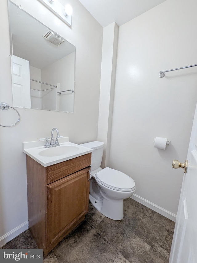 bathroom featuring toilet, visible vents, vanity, and baseboards