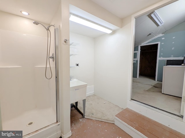 full bathroom featuring washer / clothes dryer, a shower stall, concrete floors, and vanity