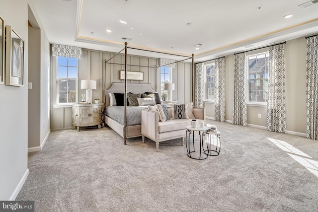 bedroom with visible vents, a raised ceiling, baseboards, and carpet floors