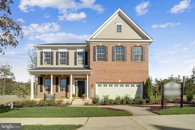 view of front of house featuring a garage, brick siding, and covered porch