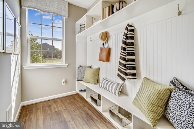 mudroom featuring baseboards and wood finished floors