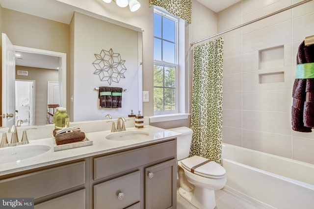 bathroom with double vanity, visible vents, and a sink